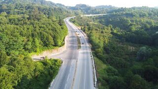 4K resolution - scenic aerial view of forest roadway in summer | Trending HD Video