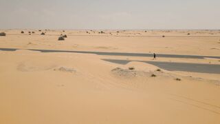 Notes on Being a Man - a desert with a man walking across it | Trending HD Video