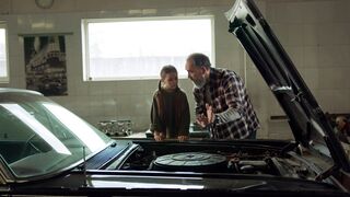 Woman - a man and woman looking at the hood of a car | Trending HD Video