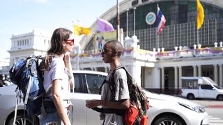 travelite - two female backpackers talking on the street side | Trending HD Video