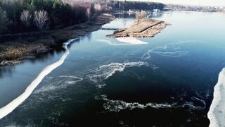 Winter solstice - aerial view of scenic frozen river in winter | Trending HD Video