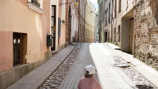 Travelpro - boy on a bicycle rides along an old narrow street | Trending HD Video