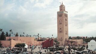 time lapse footage of a busy street in front of a building with a tower | Professional HD Video