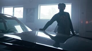 man united vs aston villa - a man standing in front of a car in a garage | Trending HD Video