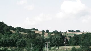 Scarred - a road with a car on it and a hill | Trending HD Video