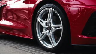 Sports - close up of sleek red sports car wheel on pavement | Trending HD Video