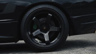 Electric car - sleek black nissan skyline on urban track | Trending HD Video