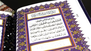 ALIEN STAGE the Art Book Deluxe Edition - close up view of a page of the quran holy book | Tren