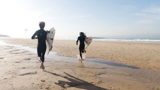 Sport Bike - surfers running towards the sea | Trending HD Video