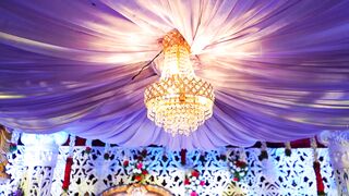 a lighted chandelier as the hanging centerpiece on an event venue | Professional HD Video