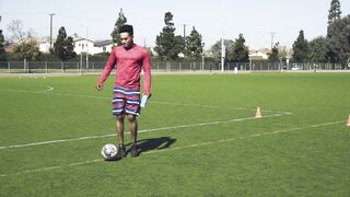 Sportsgirl - man playing with a soccer ball while holding a drink | Trending HD Video