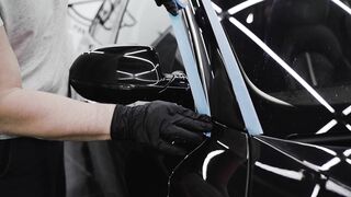 Carpet - man putting tape on the side of a car | Trending HD Video