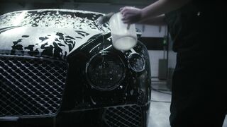 Cartier - person cleaning the car headlight | Trending HD Video