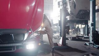 Electric car - a mechanic woman and a man assisting her | Trending HD Video