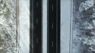 Winterhalter - drone footage of a road in the middle of a snowy forest | Trending HD Video