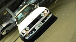 Cardigan - sleek vintage car in urban parking lot | Trending HD Video