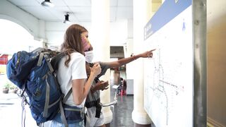 Travelpro - two persons talking to each other while looking at a map | Trending HD Video