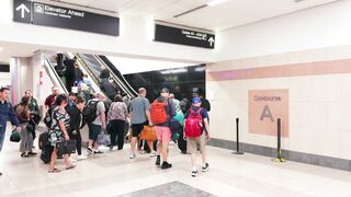 Travel Backpack - busy airport terminal with escalator traffic | Trending HD Video