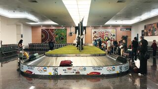 travelite - a large luggage cart in an airport with people standing around it | Trending HD Vid