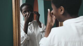 Woman Within - a woman putting under eye mask on her face | Trending HD Video