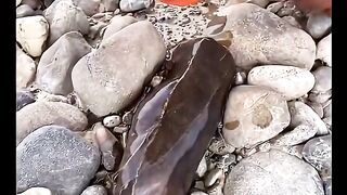 Man cracks stone open revealing perfect crytal heart inside.