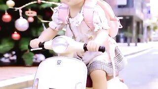 Little girl riding a scooter