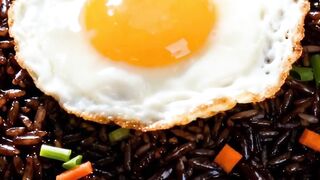 Authentic Indonesian Black Fried Rice with Sunny Side Up Egg - Delicious Traditional Breakfast