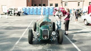 Notes on Being a Man - slow motion footage of a man taking a picture of an vintage car in the p
