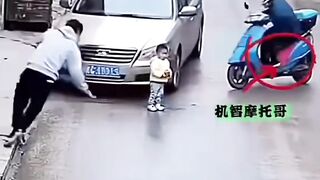 A young man deliberately crashed his motorbike to save a small child.
