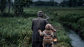 “A Quiet Night… A Grandfather and His Grandchild Walking with an Old Bicycle ????????”
