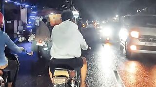 a young man riding an RX King motorbike at night