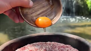 Cooking steak in forest