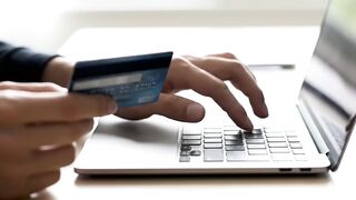 Hands Holding Credit Card and Typing on Laptop Keyboard for Online Shopping