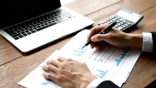 Financial Analyst Reviewing Business Growth Charts and Data