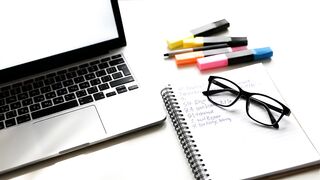 Modern Workspace with Laptop Notebook and Glasses