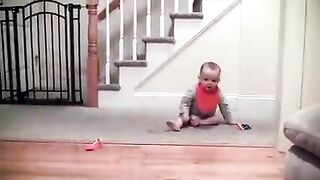 Adorable laughing baby and Cavalier King Charles playing game