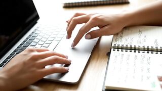 Woman Hands Using Laptop Trackpad While Working with Notebook