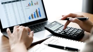 Business Professional Analyzing Financial Data on Laptop