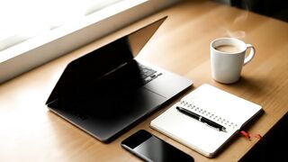 Modern Minimalist Workspace with Laptop and Steaming Coffee