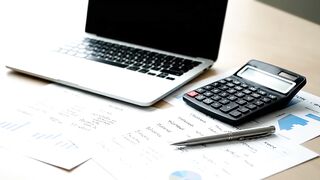 Business Financial Analysis Workspace with Laptop and Calculator