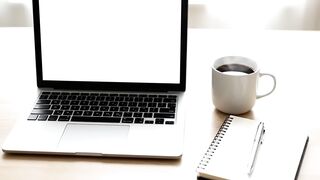 Laptop Mockup on Wooden Desk with Coffee and Notebook