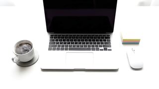 Minimalist Home Office Workspace with Laptop and Coffee
