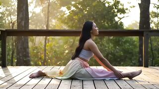 Young Woman Practicing Yoga Split Pose on Outdoor Deck at Sunrise