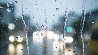 Rainy Day Window View with Blurred City Lights
