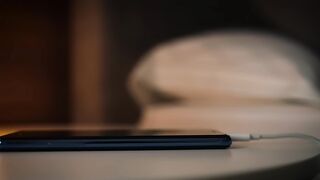Smartphone Charging at Night with Warm Lamp Light