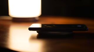 Smartphone Wirelessly Charging in Warm Light