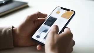 Close-up of Hands Holding Smartphone with Blank Mockup Screen