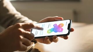 Professional Using Smartphone and Notebook in Sunlit Office
