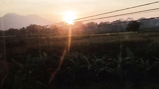 the morning sun passes through the train window