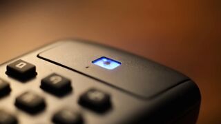 Illuminated Blue Button on Modern Electronic Device